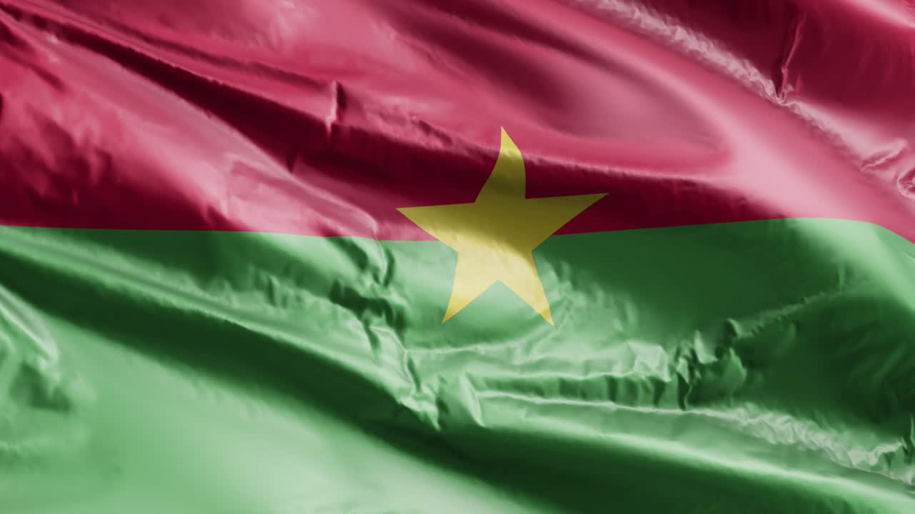 la bandera de burkina faso se agita lentamente en el bucle del viento. el estandarte de burkina faso se balancea suavemente en la brisa. fondo de relleno completo. bucle de 20 segundos.
