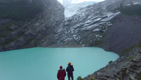 majestic view of glacial, turquoise lake huemul, sorrounded bu mountains and crowned by the huemul glacier