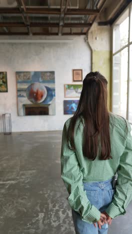 woman looking back at art gallery