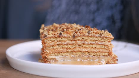 woman eating a slice of layered cake