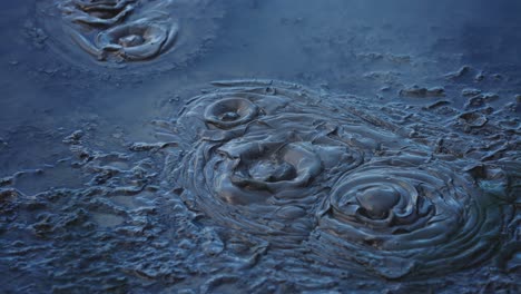 Boiling-hot-geothermal-volcanic-mud-pool,-closeup-shot-steamy-lake-bubbling-mud-and-steam