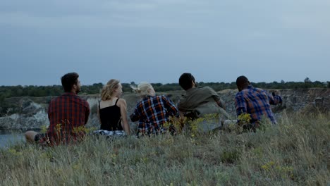 friends relaxing on cliff and having fun