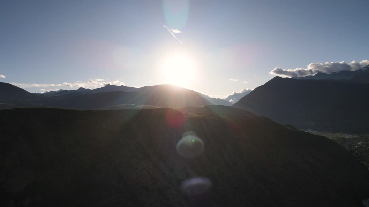 Aerial of the sun above the mountains of Urubamba, Sacred Valley, Cusco, Peru. Drone slow pan