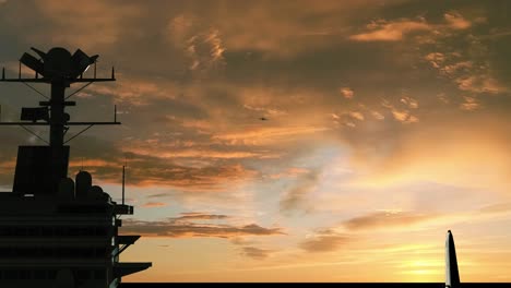 aircraft carrier at sunset