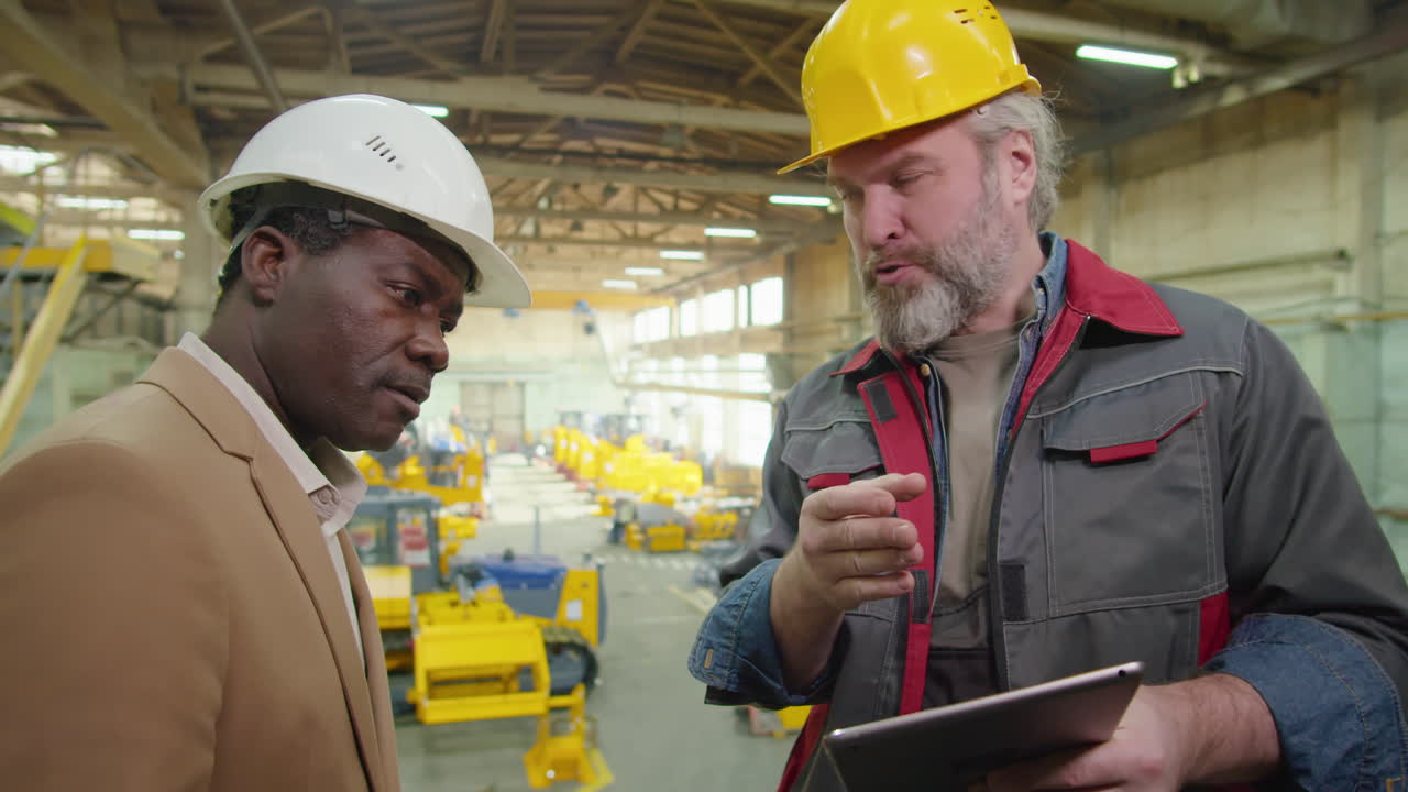 Factory Technician and Engineer Discussing Something on Tablet
