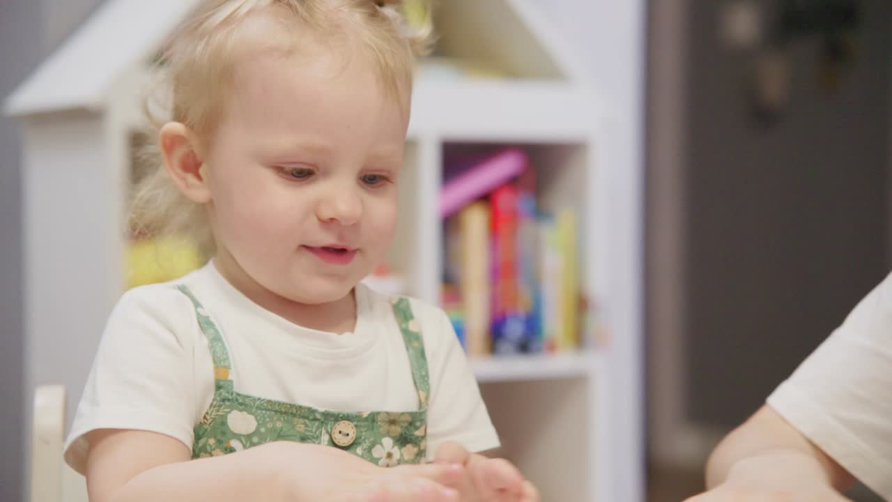 Happy Baby Girl Playing with Colorful Playdough at Home