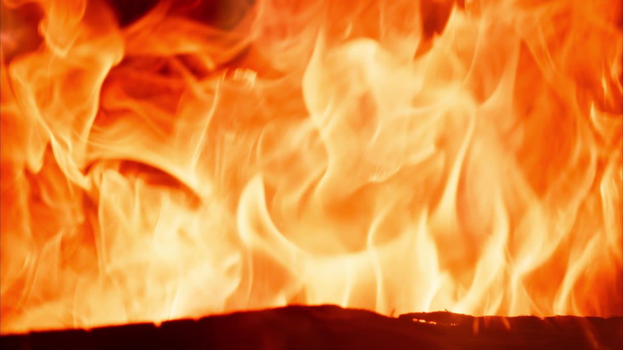 Close up of wood burning with a strong flame in a fireplace