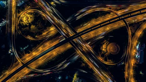 road interchange in the city at night with vehicle car light movement, aerial view.