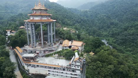 drone approach kek lok si temple penang island malaysia on top of hill rain forest