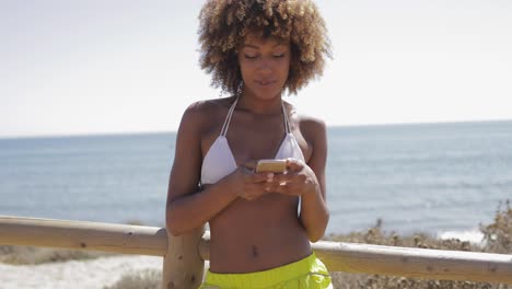 charming girl using smartphone while training