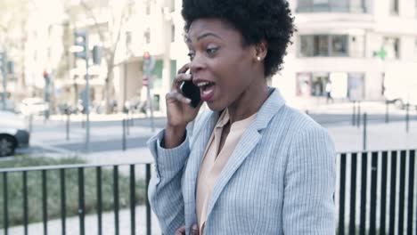 beautiful smiling woman talking on phone during stroll