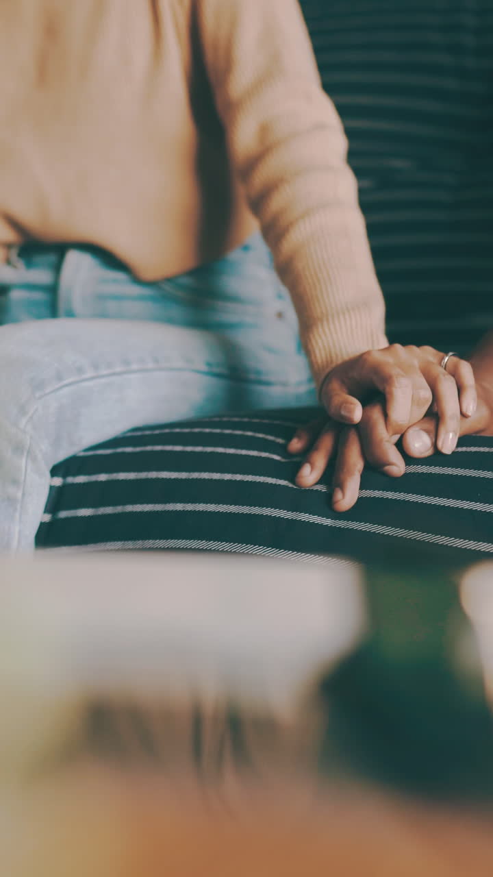 Close-up of Couple Holding Hands with Interlocked Fingers