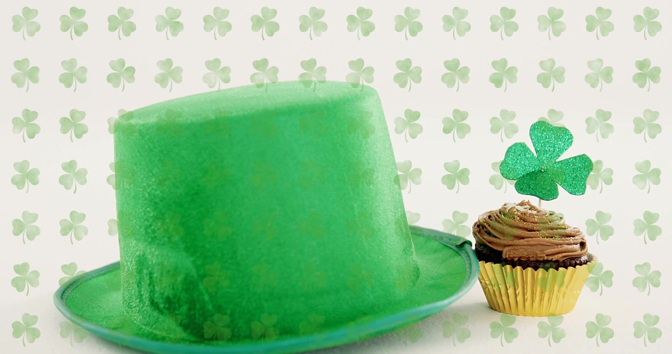 Scene starting with shamrock backdrop, green hat rising, cupcake emerging, creating festive layout