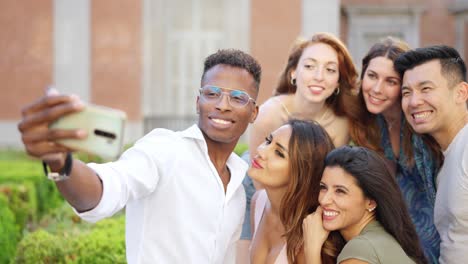 happy diverse group of friends taking a selfie outdoors