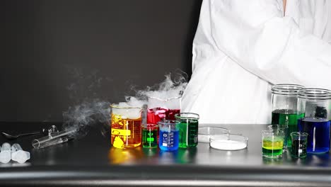 scientist conducting experiment with colorful chemicals