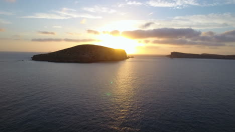 aerial shot off cliffs with sun set over sea