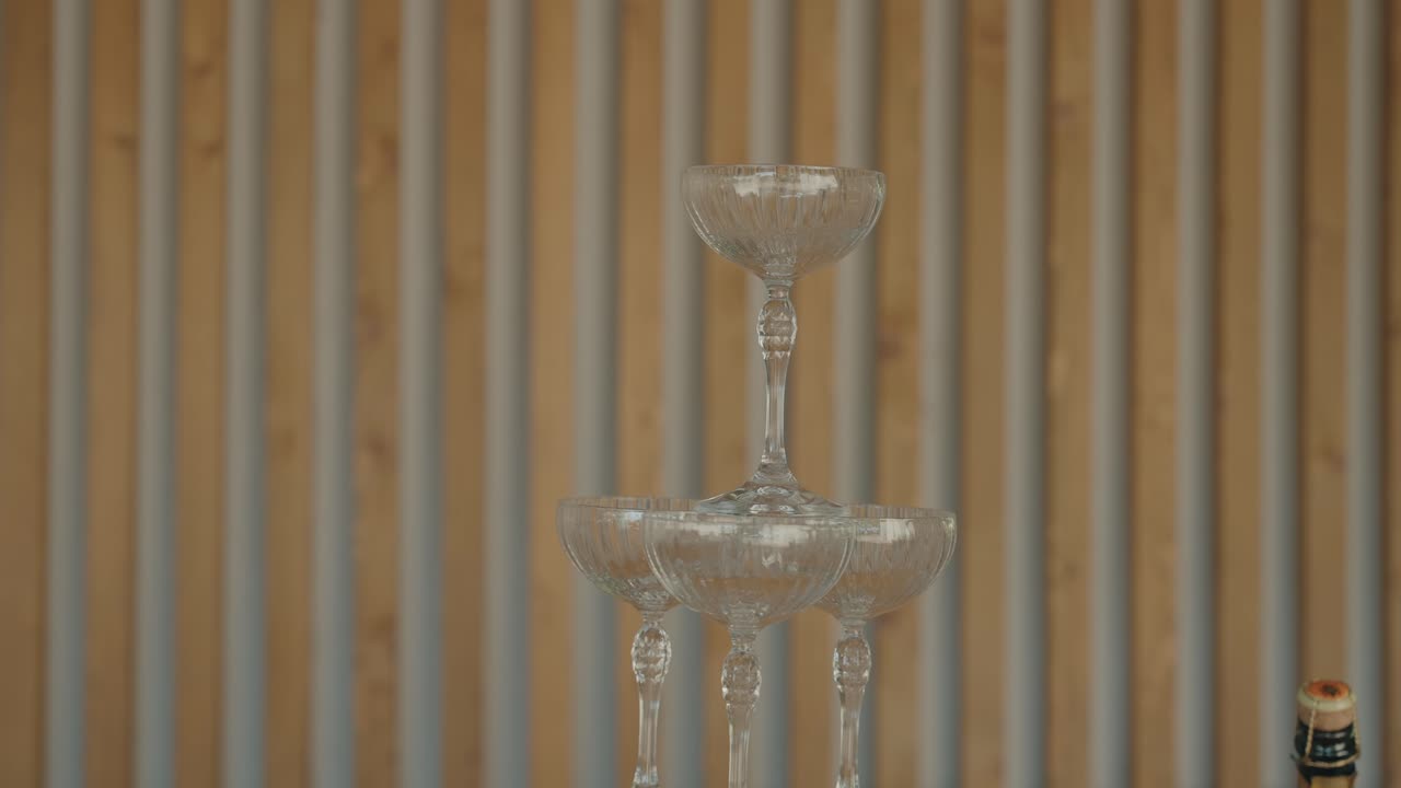 Elegant pyramid of crystal champagne glasses arranged for festive event or wedding reception