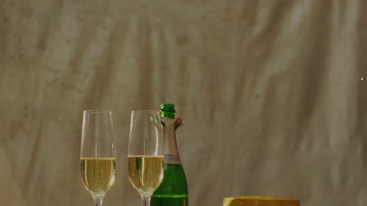 Blue helix appearing from right, overlaying flutes and green bottle, showing celebration