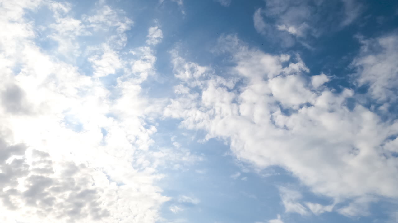 Slow transformation of spindrift clouds in the atmosphere. White clouds covering the skies low angle view. Timelapse.