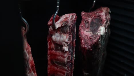 hanging raw beef steaks