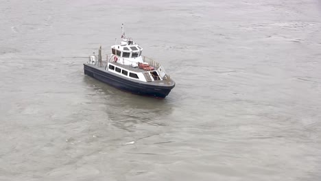 blue and white vessel maneuvers slowly in the panama canal