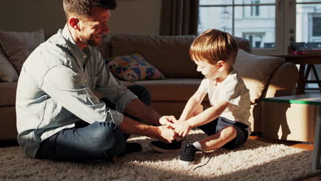father and son tying shoes