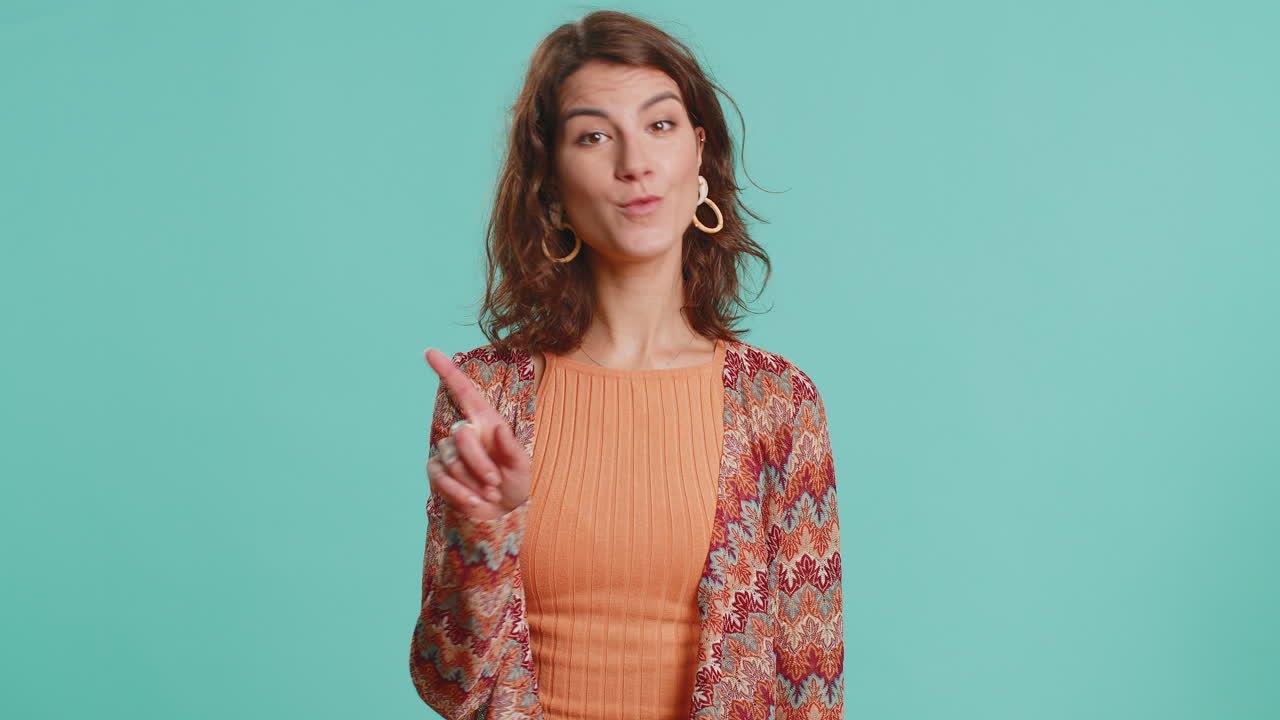 Attractive woman shakes finger and saying no be careful avoid danger mistake disapproval sign