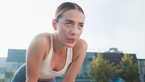 tired young athlete woman jogger in sportswear resting after hard training in urban city park