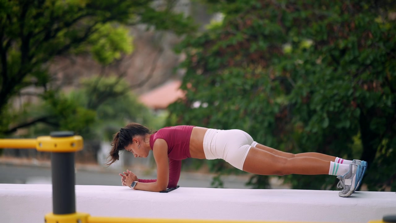 Young Woman Holding Plank Position During Outdoor Workout