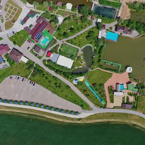 recreation area in summer. modern relaxing complex near the lake in the countryside. roofs of new hotel buildings among green nature. top view.