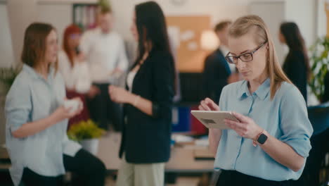 Businesswoman-using-tablet-PC-in-office.