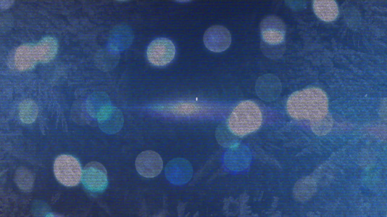 Each second glitch lines shifting over static blurred light orbs, creating subtle digital motion