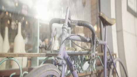 vintage purple bicycle by shop window