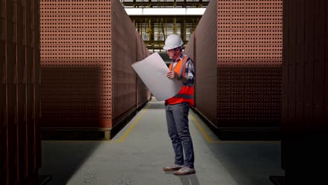 brick factory worker reviewing plans