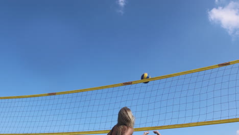 girls playing beach volleyball.