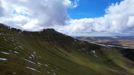 Drone-pullback-reveals-Corn-Du-and-Pen-y-Fan-snowy-summits-with-hikers