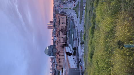 vertical footage left to right pan shot of madrid skyline view from las tablas viewpoing during colorful beautiful sunset with orange clouds and glow