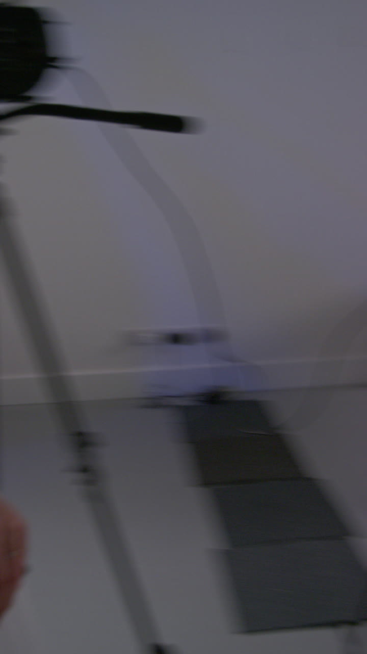 Vertical Video Of Female Assistant Using Clapperboard As Actors Shoot Movie In Studio With Film Crew And Director