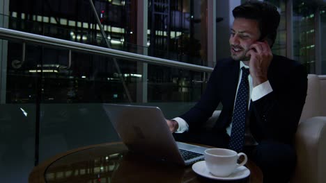 middle eastern businessman working with laptop smart phone