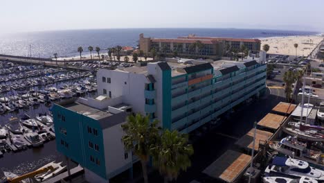 aerial descending and panning shot of the residential apartments at king harbor marina in redondo beach, california