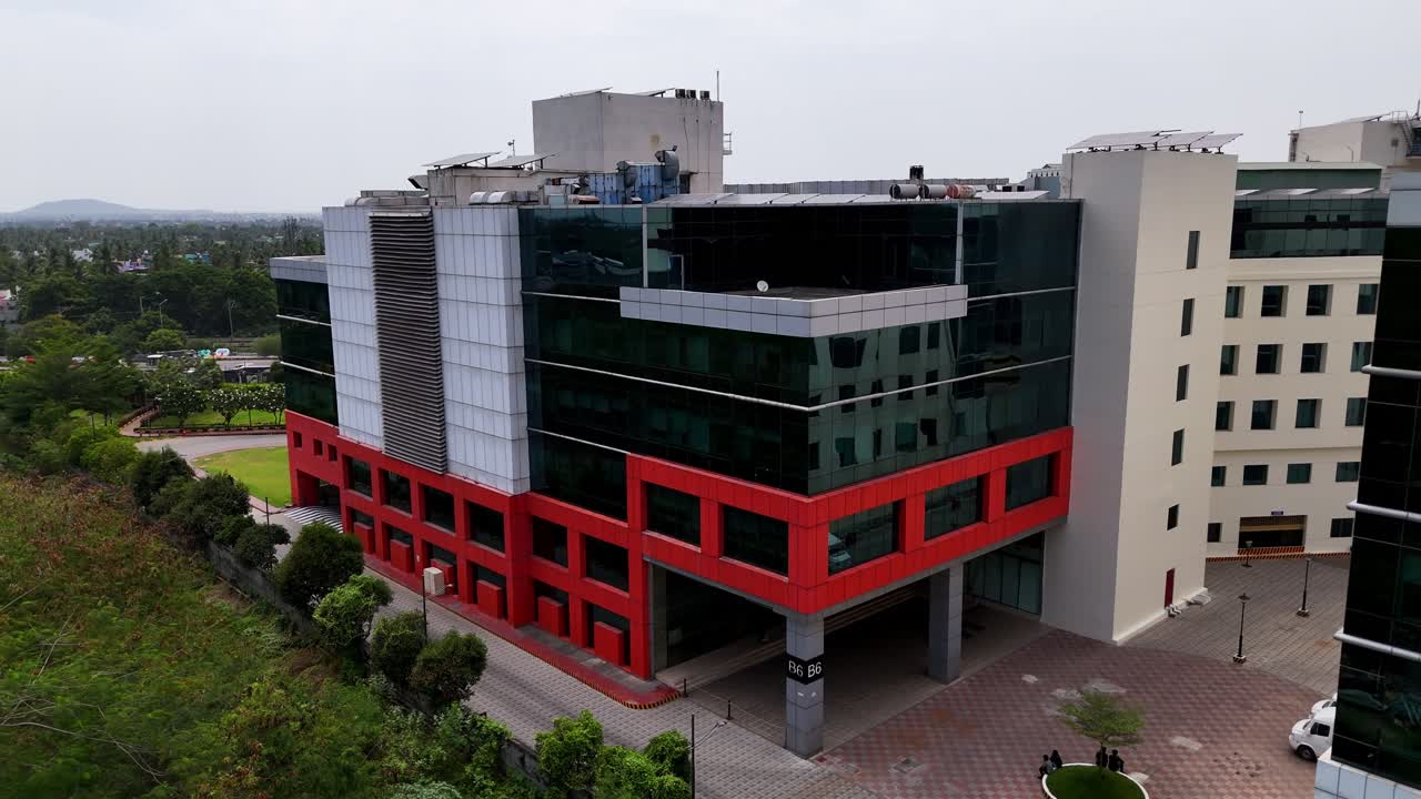 Urban Growth and Environment: Drone footage capturing a sprawling commercial centre and a busy urban roadway. Highlights modern architecture and renewable power generation