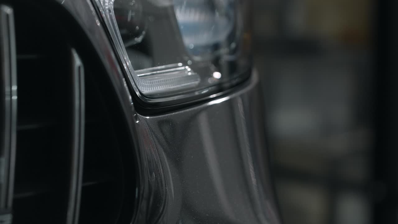 Close-up view of a car's front bumper and headlights.