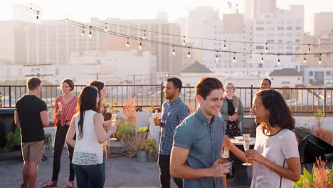 friends gathered on rooftop terrace for party with city skyline in background