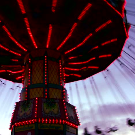 A-merry-go-round-spins-with-riders-against-the-sky