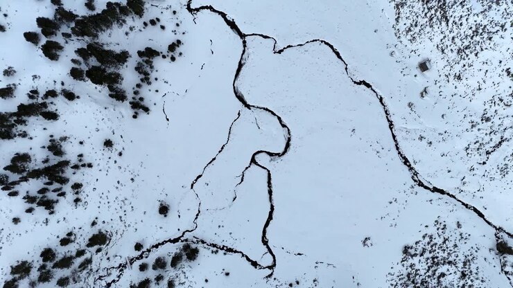 Droneopptak ovenfra av en frossen elv i Pyreneene