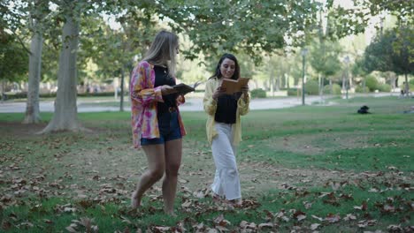 two women reading in a park