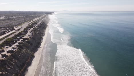 a beautiful aerial drone shot, drone descending to the beach, carlsbad state beach - california