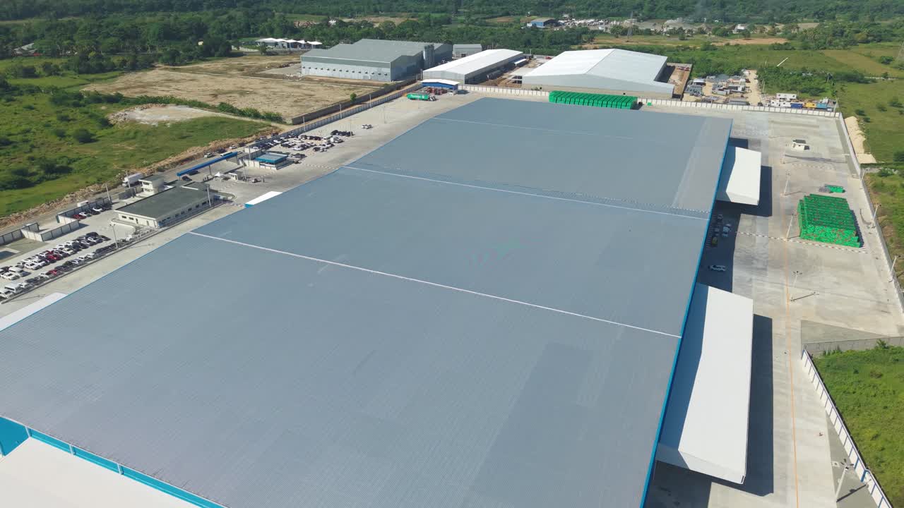 Cervecería Nacional Dominicana, brewery warehouse, industrial complex and rural landscape. Aerial drone orbiting