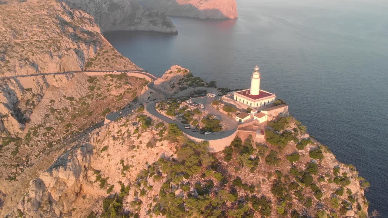 Aerial footage of lighthouse on the island sorrounded by the mountains