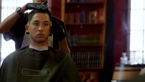man getting his hair trimmed with scissor 4k